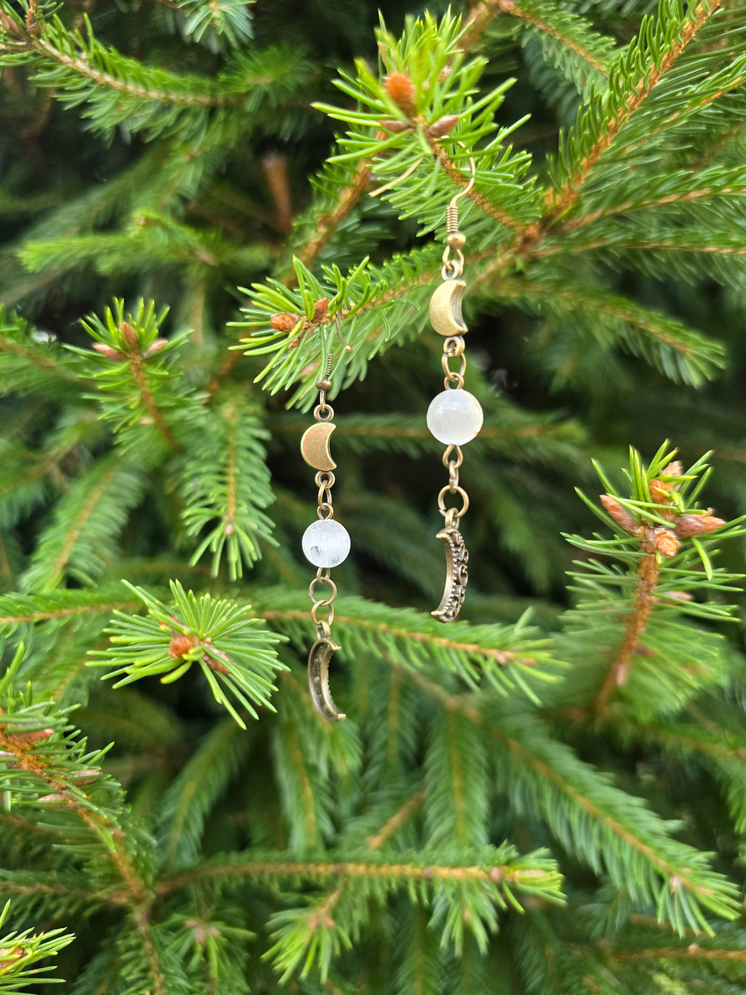 Image 6: Moonstone moon earrings detail – intricate filigree bronze crescent design