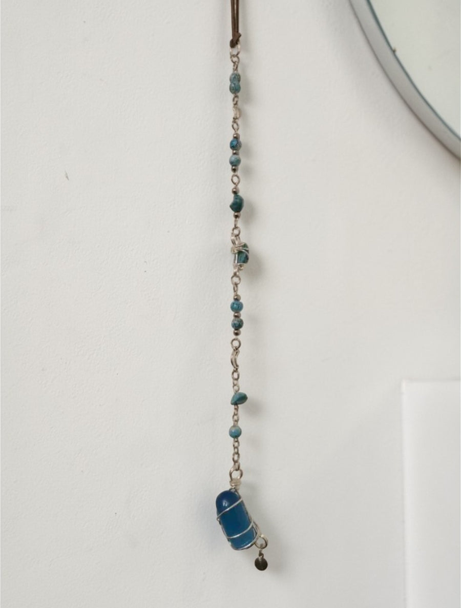 Image 6: Handmade blue gemstone wall hanging detail – decorative bead strand and crystal pendant